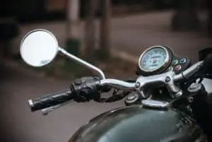 partial view of Triumph Motorcycle Front with handlebars and mirror 