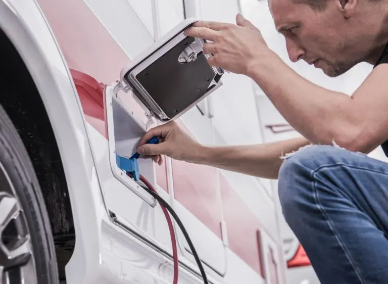 RV battery installation Technician installing new RV electrical hook up