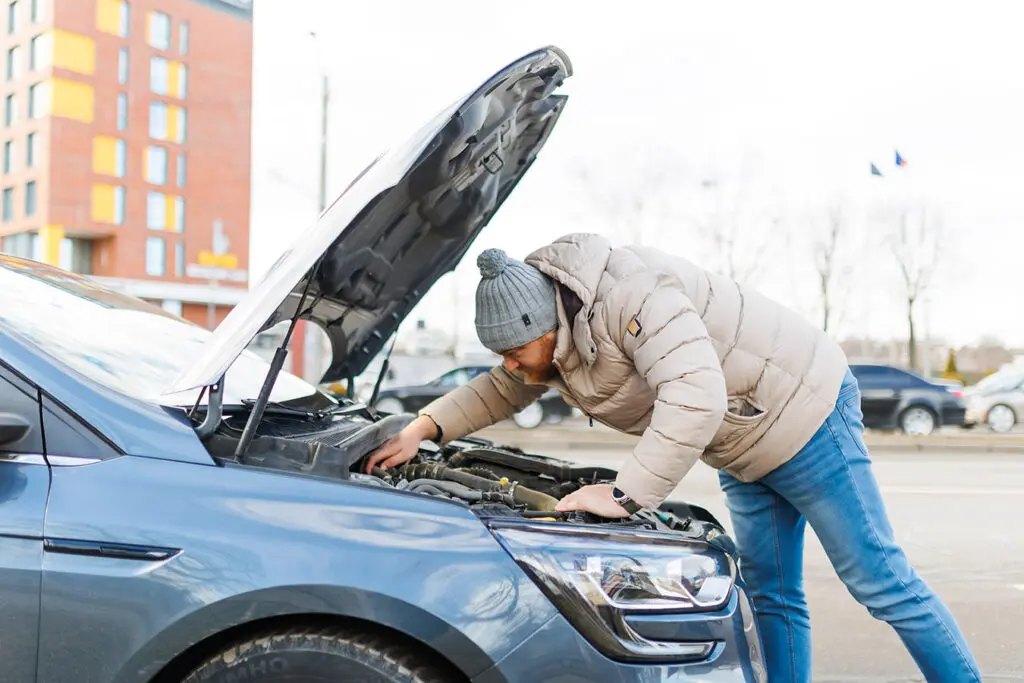 Man-checking-his-car-engine-to-diagnose-issues