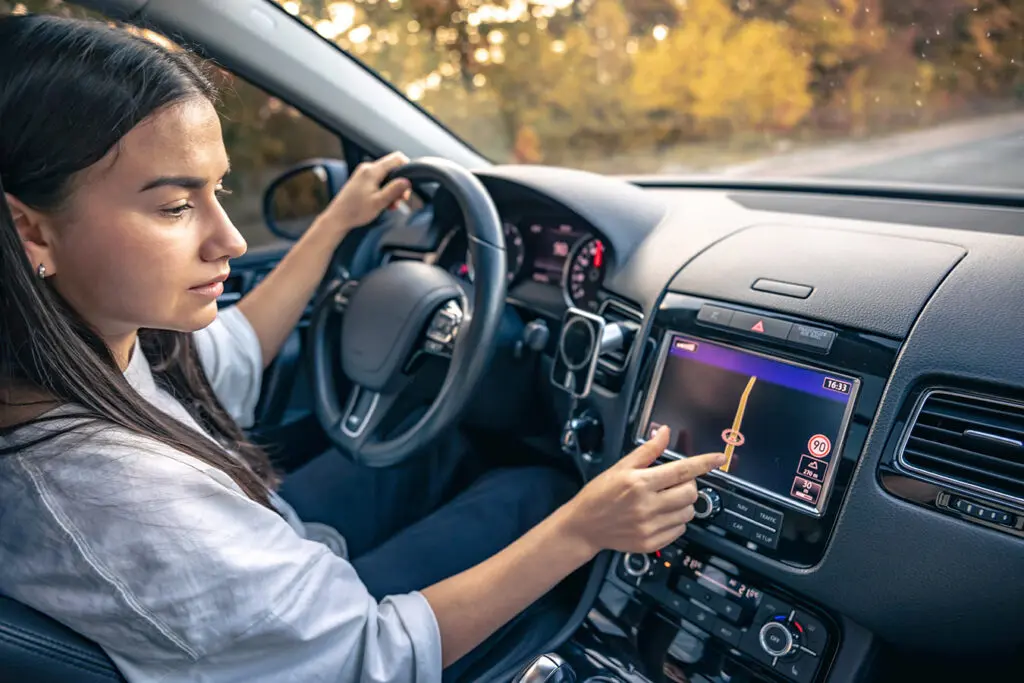 Woman-using-electronics-in-her-car