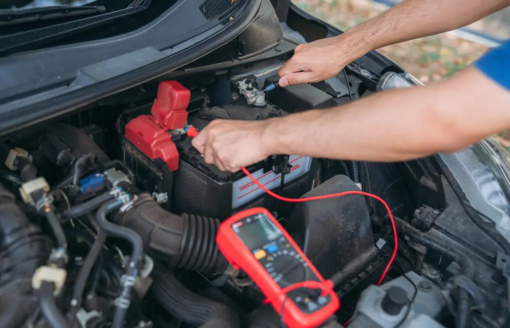 Man-testing-his-car-battery-during-fall-before-winter-snows-fly