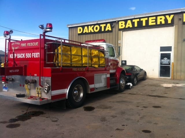 Red fire truck in front of dakota battery warehouse