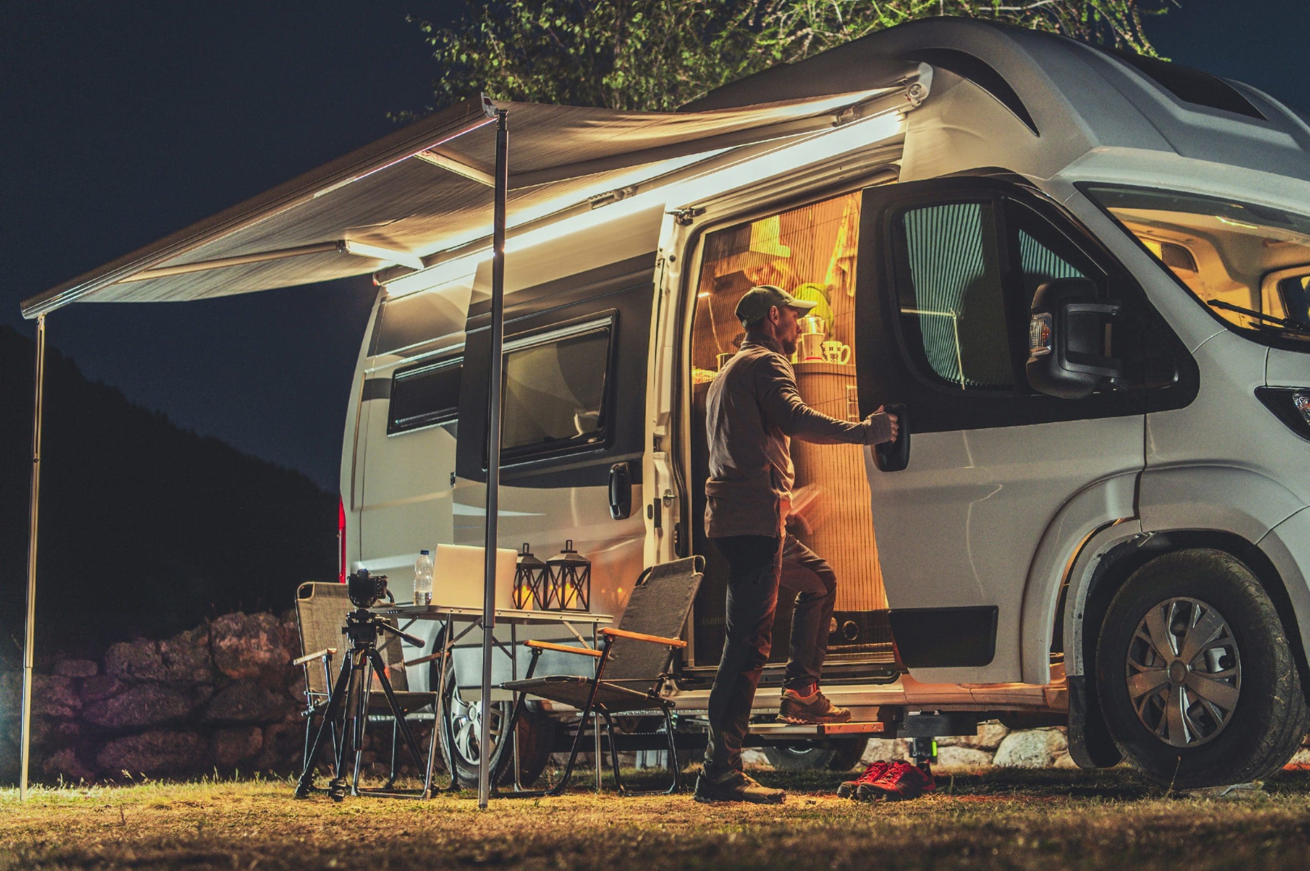 man opening the door RV with a shelter