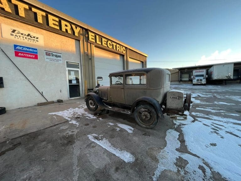 Gray Model A in front of Dakota battery electric building