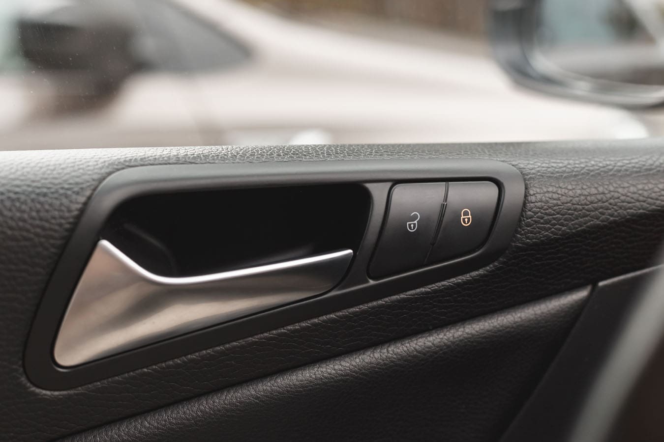 Close up of automotive door lock controls in a car.