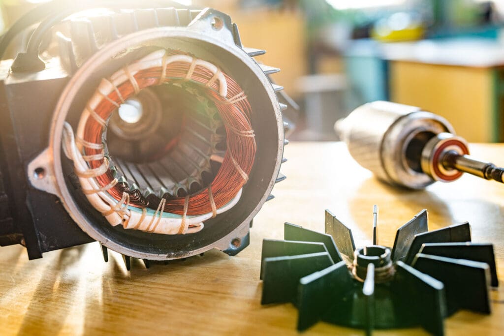 Close up of AC electrical motor disassembled and in need of repair or replacement.